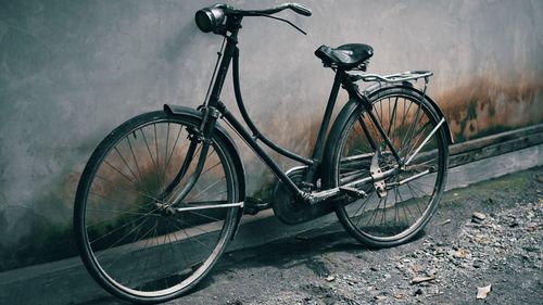 Bicycle leaning against wall