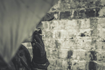 Cropped image of man smoking cigarette outdoors