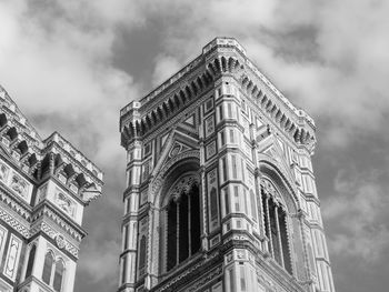 Low angle view of building against cloudy sky