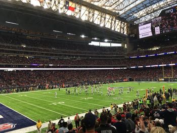 Crowd playing soccer on field