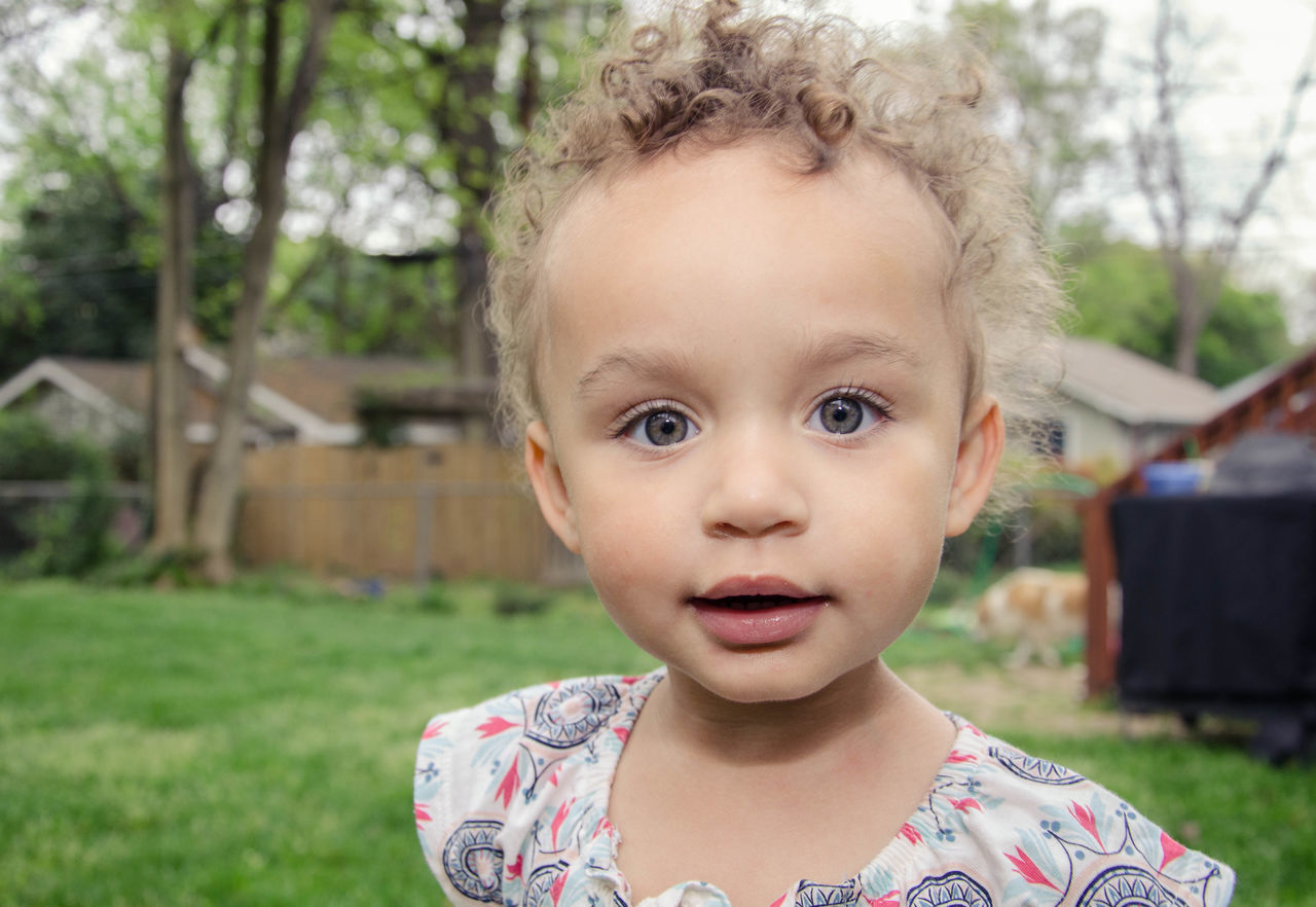 childhood, person, focus on foreground, elementary age, portrait, looking at camera, headshot, cute, innocence, lifestyles, front view, leisure activity, people, close-up, casual clothing, park - man made space, smiling