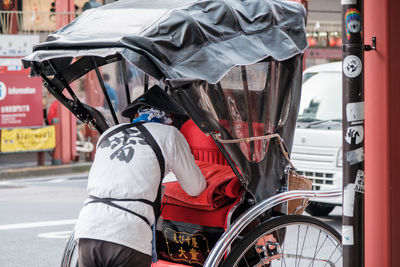 Man riding bicycle on road in city