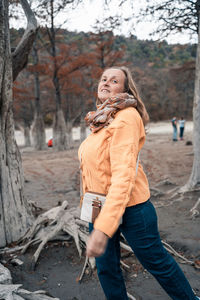 Side view of young woman standing on land