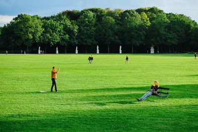 People playing soccer on field