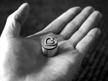 Close-up of hand holding heart shape object