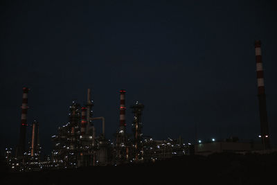 Illuminated city against sky at night