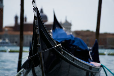 Man on boat in canal against blue sky