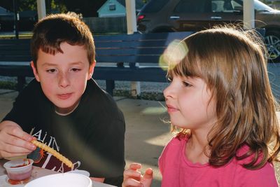 Girl sitting with brother