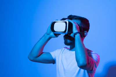 Man photographing against clear blue sky