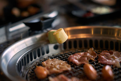 Close-up of meat in cooking pan grill