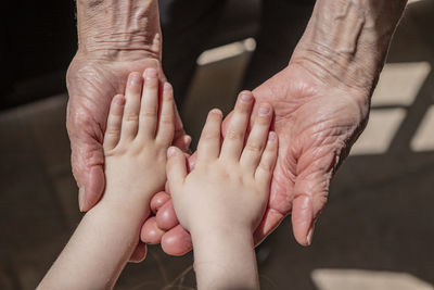 High angle view of cropped hands