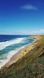 Scenic view of beach against cloudy sky