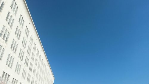 Low angle view of built structure against clear blue sky