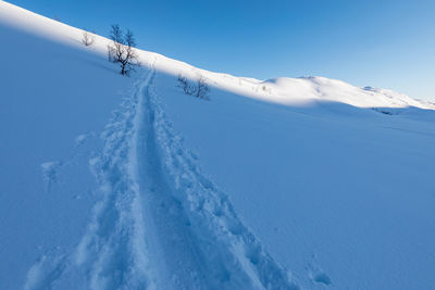 Scenic view of snow covered mountain against sky