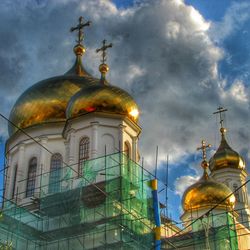 Low angle view of church against cloudy sky