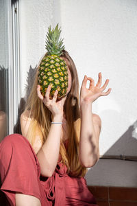 Midsection of woman holding fruits