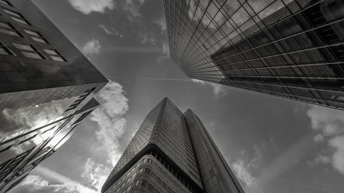 Low angle view of modern building against cloudy sky