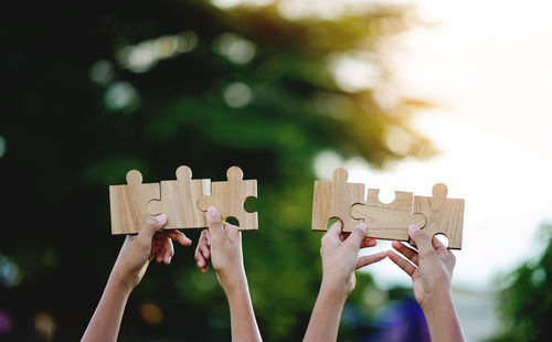 Cropped hand holding jigsaw pieces