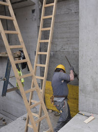 Low angle view of man working at construction site