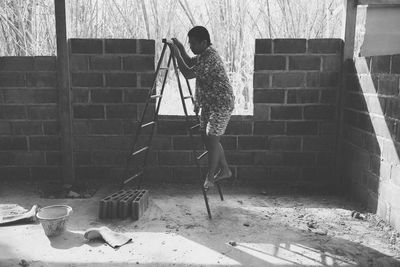 Woman working on wall