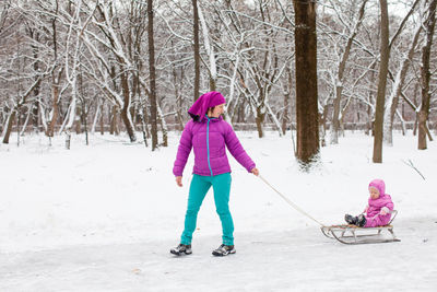 Full length of woman on road during winter