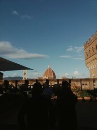 Rear view of people walking in city