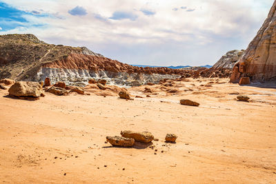 Rock formation on beach against sky