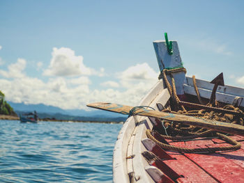 Fishing boat sailing in sea against sky