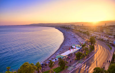 High angle view of road by sea against sky during sunset