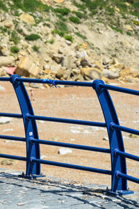 Blue ribbon tied to railings on beach