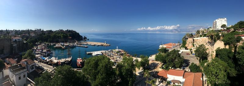 High angle view of city by sea against sky