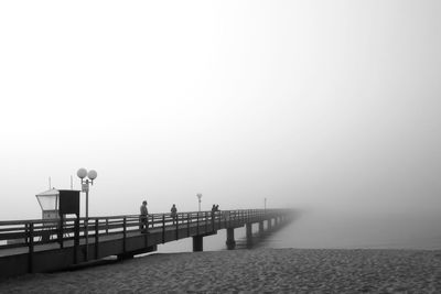 Pier over sea in foggy weather