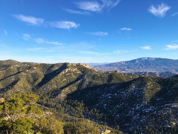 Scenic view of mountains against blue sky