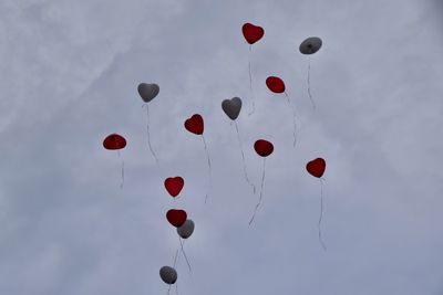 Low angle view of balloons against sky