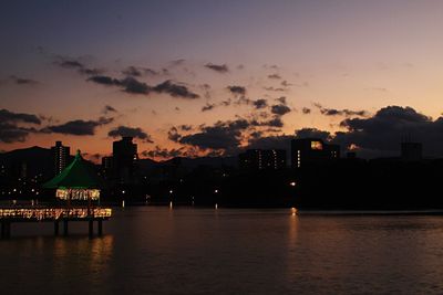 Illuminated city against sky at night