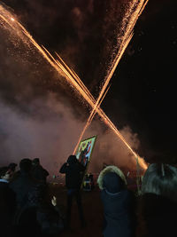 Low angle view of firework display at night