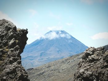 Scenic view of mountains against cloudy sky