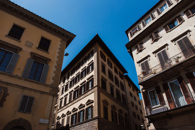 Low angle view of buildings against blue sky