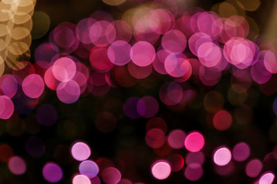 Blurry and defocused of glittery illuminated bokeh on dark background. 