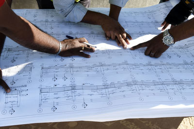 High angle view of people working on table