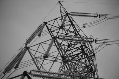 Low angle view of electricity pylon against sky