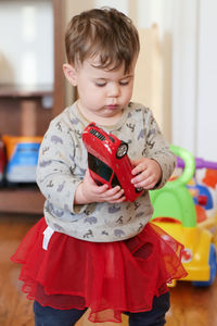 Baby boy playing in his sister's skirt