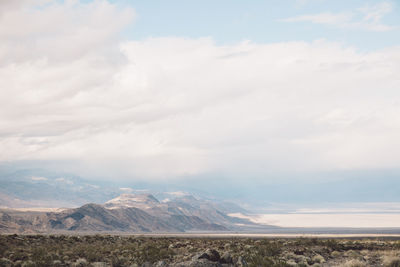 Scenic view of mountains against cloudy sky