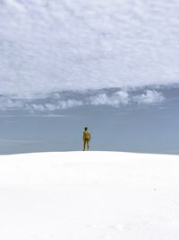 Man walking on snow covered land