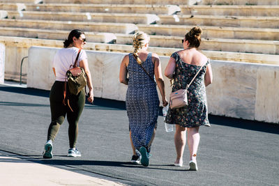 Rear view of people walking outdoors