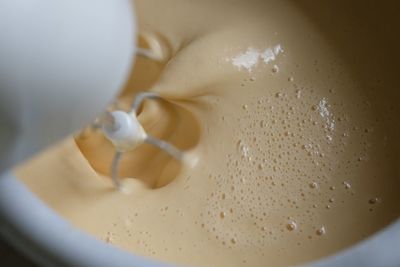 Cropped image of electric beater mixing batter