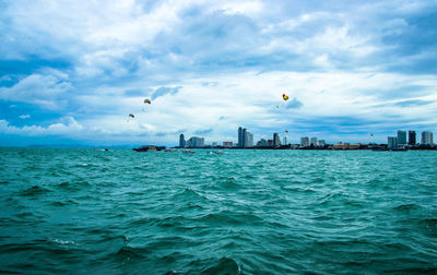 Scenic view of sea and buildings against sky