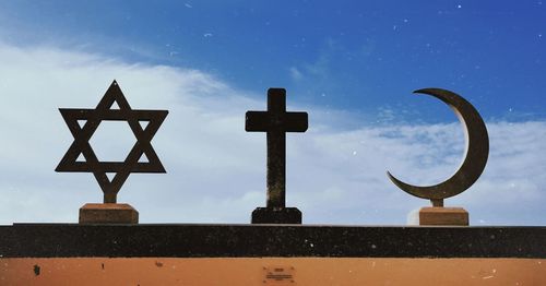 Low angle view of cross against blue sky