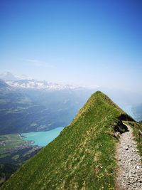 Scenic view of mountains against blue sky