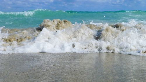 Scenic view of sea waves splashing on shore